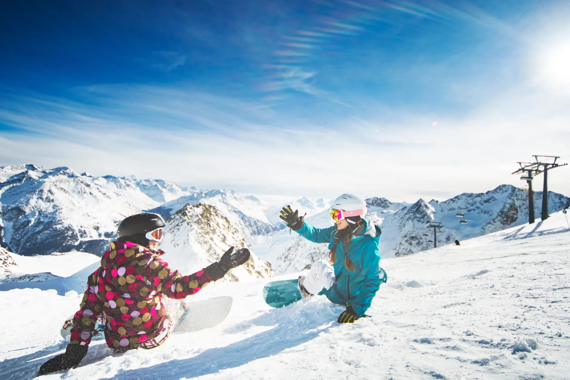 Twee lachende snowboarders in de sneeuw