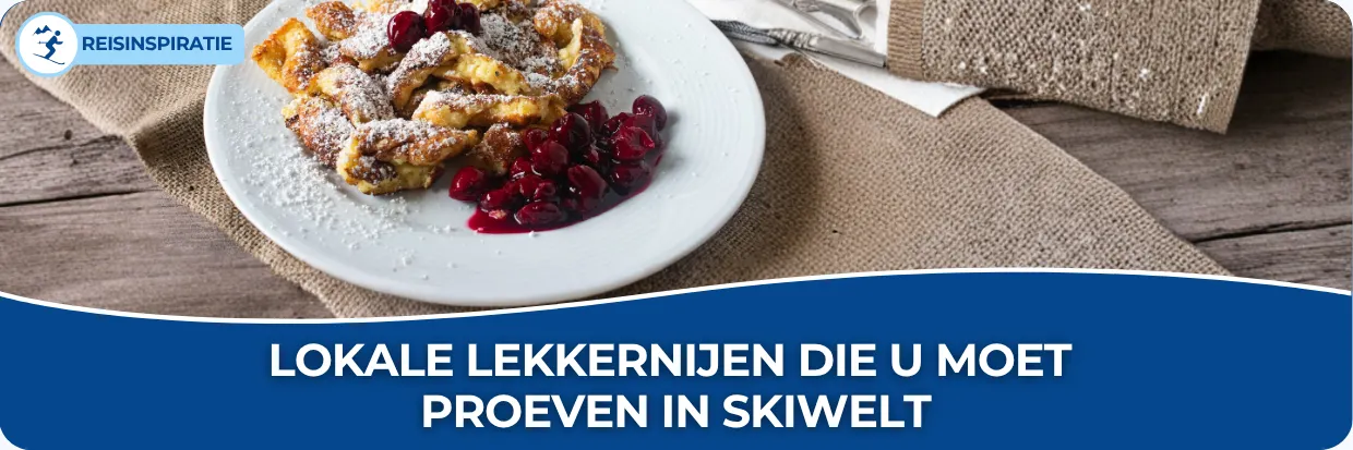 Banner voor de blog met titel Lokale lekkernijen die u moet proeven in SkiWelt. Op de afbeelding staat een bord met kaiserschmarrn met warme kersen.