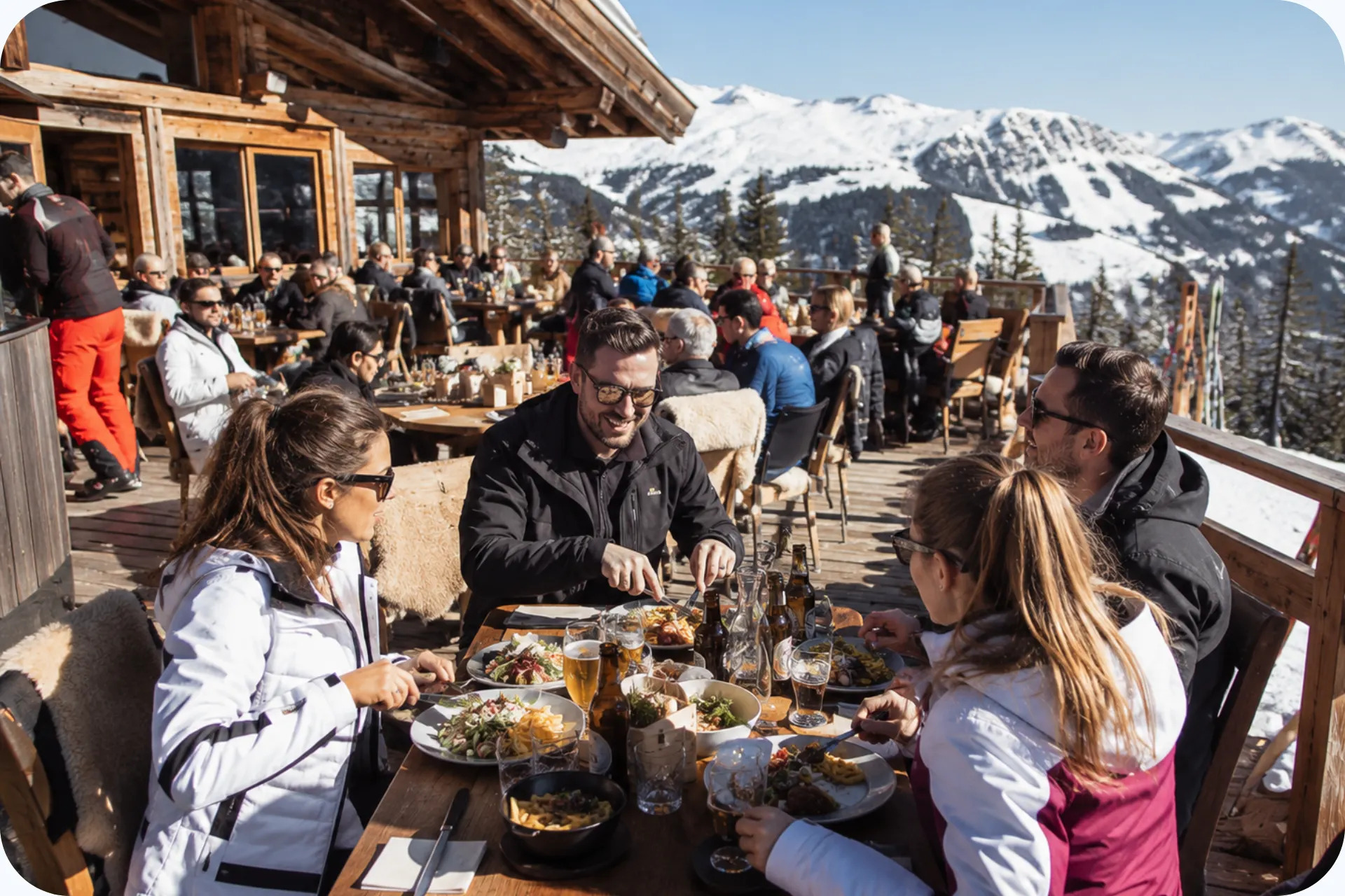 Skiërs die bij een moderne skihut genieten van een lekkere lunch in KitzSki.